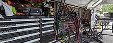 the belly bay of a tv truck with drawers of tools and cables hanging